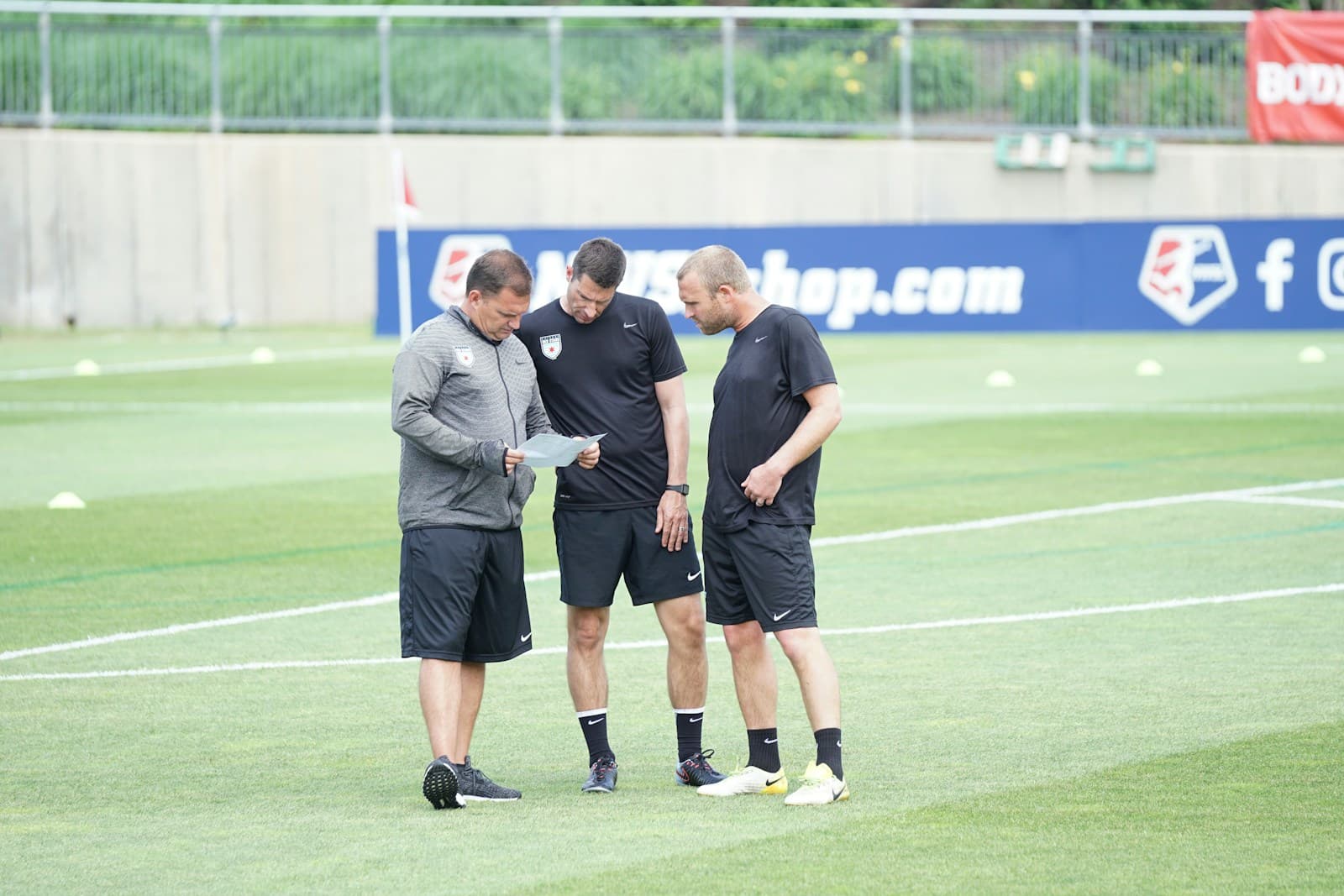 Performance analyst reviewing real-time pitch telemetry in stadium tunnel